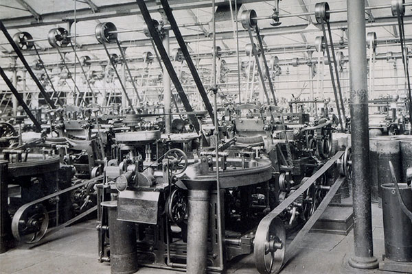 B1-032.3.7: Nip comber in middle of photograph driven by overhead belts in combing shed in Salts Mill