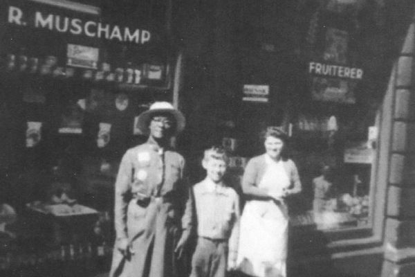 2019.54.4: Ivy Muschamp outside her shop with son and Jamaican visitor